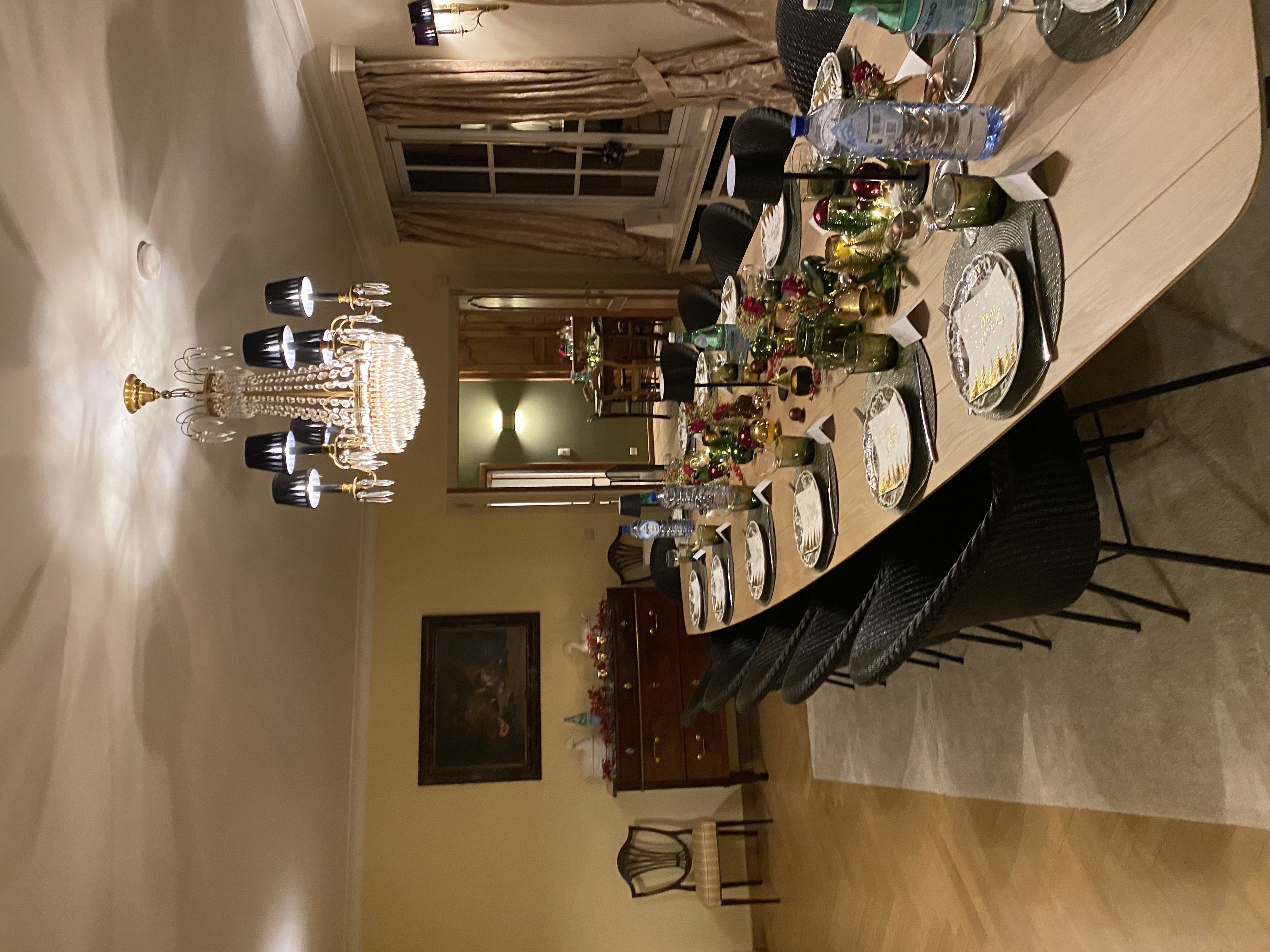 Salle à manger festive avec longue table en bois et chaises noires tressées